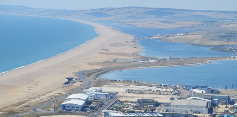 Chesil Beach. 21st August 2018. Two males enjoy swimming off Chesil Beach,  Portland, in Dorset, the